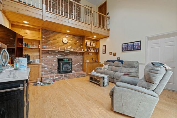 Fireplace, Interior, Living room, Recessed Lighting, Stone Walls, Wood Texture Flooring