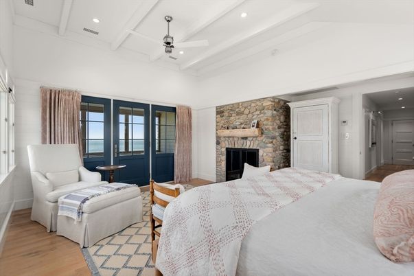 Bedroom, Fireplace, Interior, Recessed Lighting, Stone Walls, Water, Wood Texture Flooring
