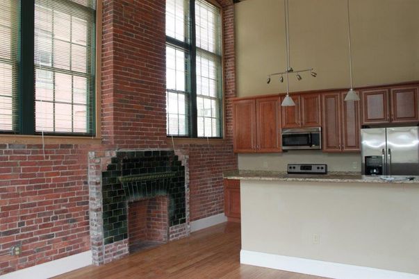Fireplace, Interior, Kitchen, Pendant Lights, Stainless Steel Appliances, Stone Walls, Wood Texture Flooring