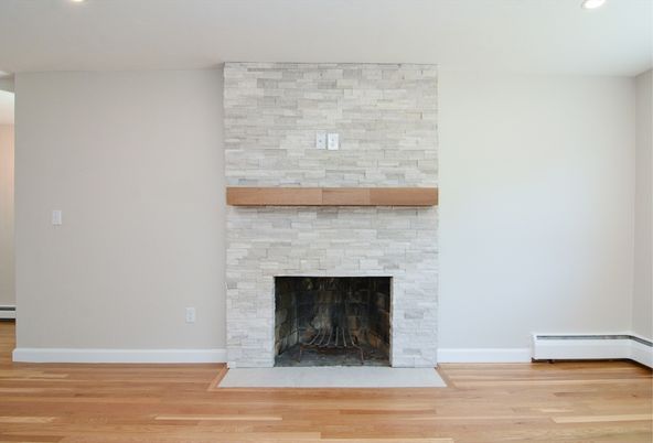 Empty room, Fireplace, Interior, Recessed Lighting, Stone Walls, Wood Texture Flooring