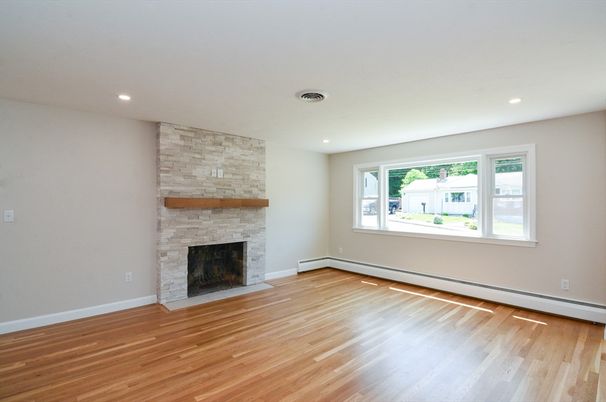 Empty room, Fireplace, Interior, Recessed Lighting, Stone Walls, Wood Texture Flooring