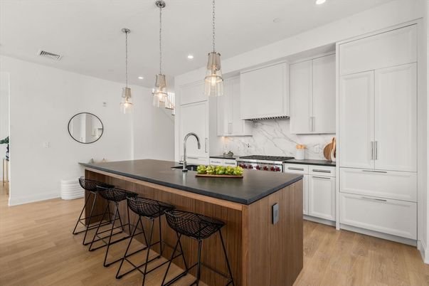 Interior, Kitchen, Marble Walls, Pendant Lights, Recessed Lighting, Stainless Steel Appliances, Wood Texture Flooring