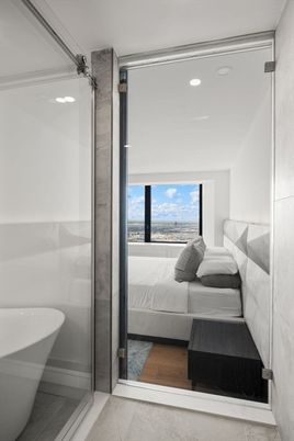Bathroom, Bedroom, Glass Shower, Interior, Recessed Lighting, Water, Wood Texture Flooring