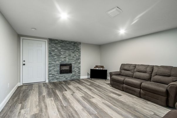 Fireplace, Interior, Living room, Recessed Lighting, Stone Walls, Wood Texture Flooring