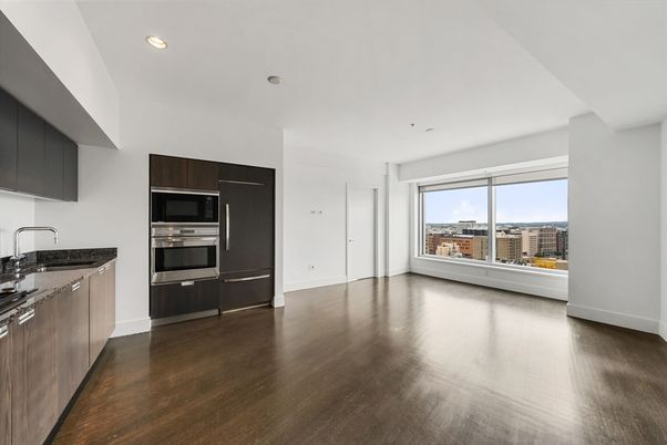Empty room, Interior, Kitchen, Recessed Lighting, Stainless Steel Appliances, Wood Texture Flooring