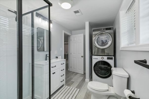 Bathroom, Glass Shower, Interior, Utility Closets, Washer, Wood Texture Flooring