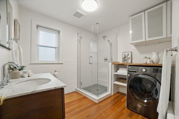 Bathroom, Glass Shower, Interior, Washer, Wood Texture Flooring
