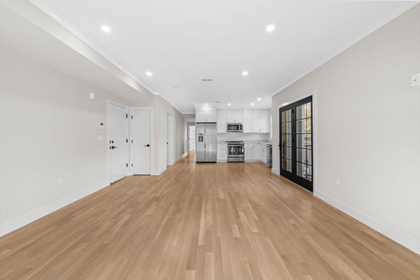 Empty room, Interior, Kitchen, Recessed Lighting, Stainless Steel Appliances, Wood Texture Flooring