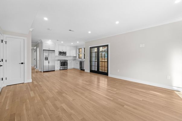 Empty room, Interior, Kitchen, Recessed Lighting, Stainless Steel Appliances, Wood Texture Flooring