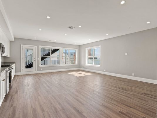 Empty room, Interior, Kitchen, Recessed Lighting, Stainless Steel Appliances, Wood Texture Flooring