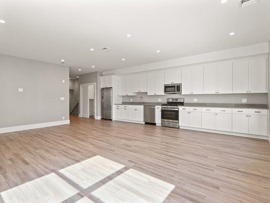 Empty room, Interior, Kitchen, Recessed Lighting, Stainless Steel Appliances, Wood Texture Flooring