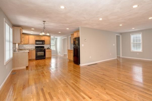 Empty room, Interior, Kitchen, Pendant Lights, Recessed Lighting, Stainless Steel Appliances, Wood Texture Flooring