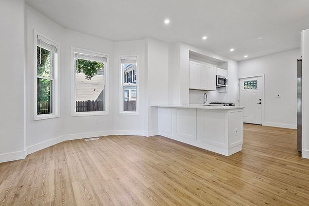 Empty room, Interior, Kitchen, Recessed Lighting, Stainless Steel Appliances, Wood Texture Flooring