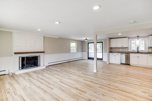 Empty room, Fireplace, Interior, Kitchen, Pendant Lights, Recessed Lighting, Stainless Steel Appliances, Wood Texture Flooring