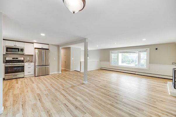 Empty room, Interior, Kitchen, Recessed Lighting, Stainless Steel Appliances, Wood Texture Flooring