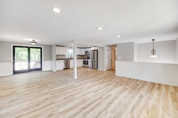 Empty room, Interior, Kitchen, Pendant Lights, Recessed Lighting, Stainless Steel Appliances, Wood Texture Flooring
