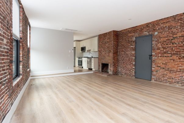 Empty room, Fireplace, Interior, Kitchen, Recessed Lighting, Stone Walls, Wood Texture Flooring