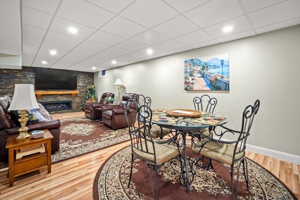 Dining room, Fireplace, Interior, Living room, Recessed Lighting, Stone Walls, Wood Texture Flooring