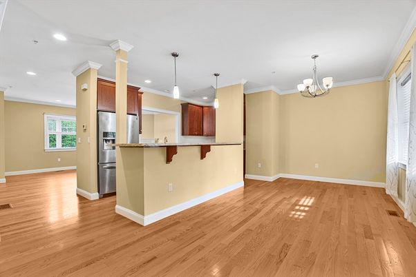 Chandelier, Empty room, Interior, Kitchen, Pendant Lights, Recessed Lighting, Stainless Steel Appliances, Wood Texture Flooring