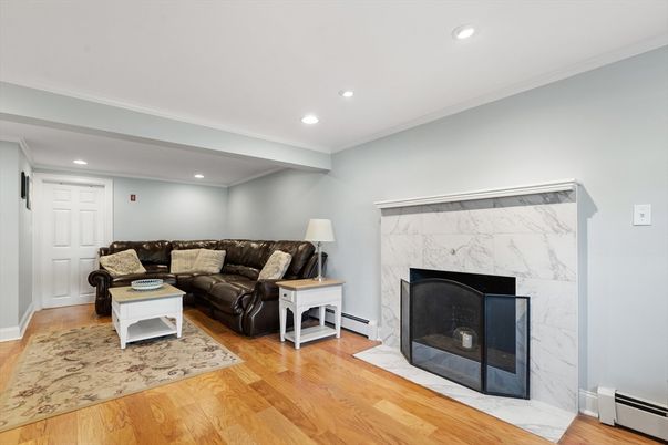 Fireplace, Interior, Living room, Marble Walls, Recessed Lighting, Wood Texture Flooring
