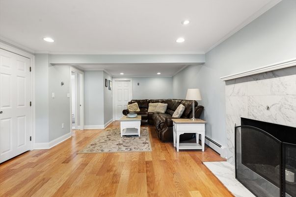 Fireplace, Interior, Living room, Marble Walls, Recessed Lighting, Wood Texture Flooring