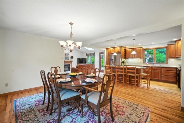 Chandelier, Dining room, Fireplace, Interior, Kitchen, Pendant Lights, Recessed Lighting, Stainless Steel Appliances, Wood Texture Flooring