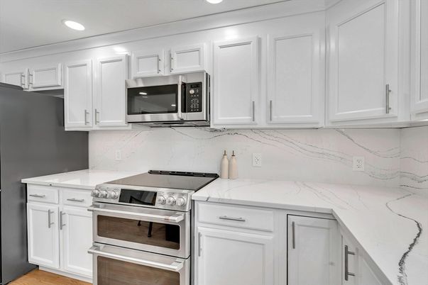 Interior, Kitchen, Marble Walls, Recessed Lighting, Stainless Steel Appliances, Wood Texture Flooring