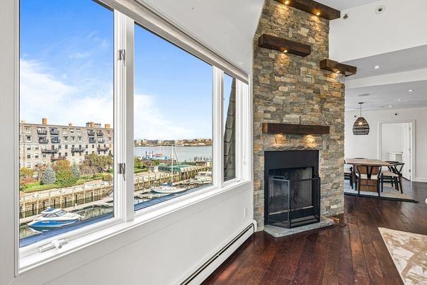 Dining room, Fireplace, Interior, Pendant Lights, Recessed Lighting, Stone Walls, Water, Wood Texture Flooring