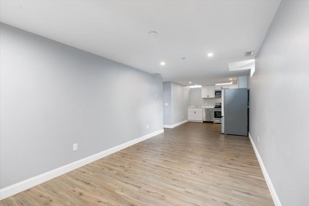 Empty room, Interior, Kitchen, Recessed Lighting, Stainless Steel Appliances, Wood Texture Flooring
