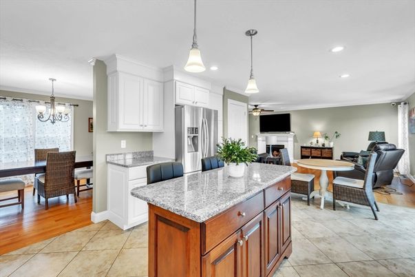 Chandelier, Dining room, Fireplace, Interior, Kitchen, Living room, Pendant Lights, Recessed Lighting, Stainless Steel Appliances, Wood Texture Flooring