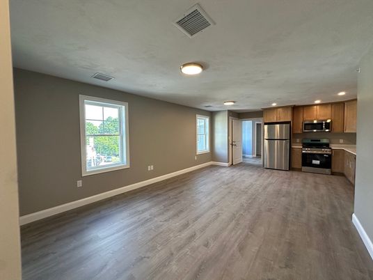 Empty room, Interior, Kitchen, Recessed Lighting, Stainless Steel Appliances, Wood Texture Flooring