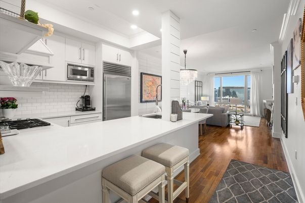 Chandelier, Dining room, Interior, Kitchen, Living room, Pendant Lights, Recessed Lighting, Stainless Steel Appliances, Water, Wood Texture Flooring