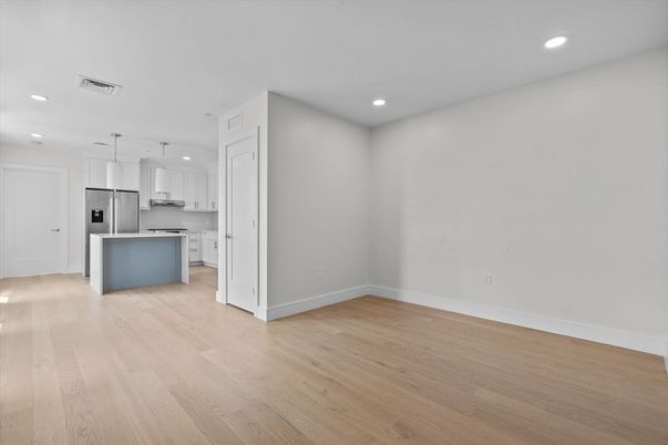 Empty room, Interior, Kitchen, Pendant Lights, Recessed Lighting, Stainless Steel Appliances, Wood Texture Flooring