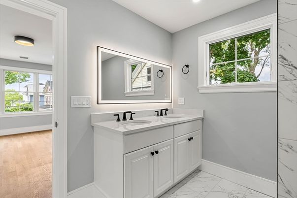 Bathroom, Dual Sink Vanities, Interior, Marble, Marble Walls, Recessed Lighting, Wood Texture Flooring