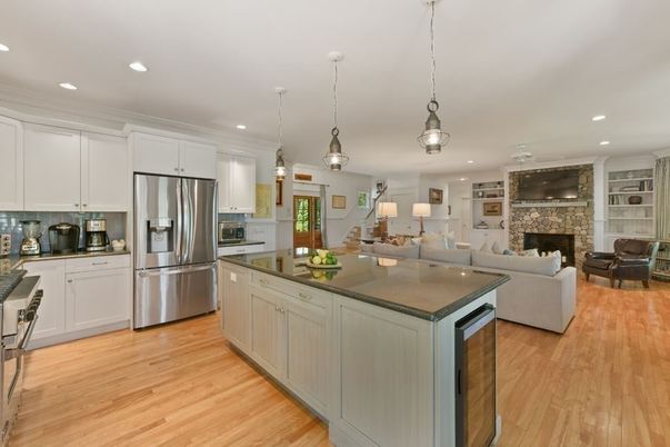 Fireplace, Interior, Kitchen, Living room, Pendant Lights, Recessed Lighting, Stainless Steel Appliances, Stone Walls, Wood Texture Flooring