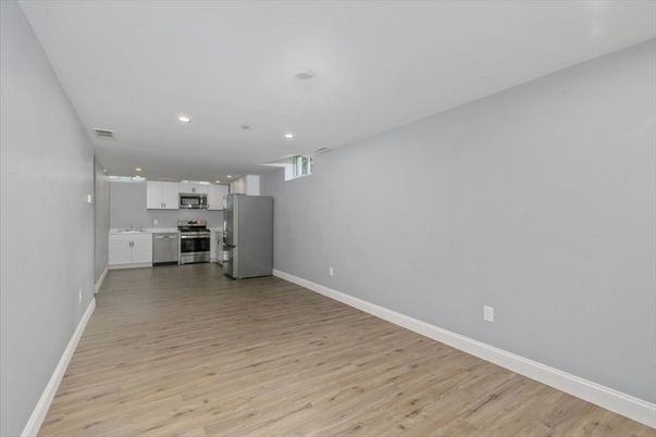 Empty room, Interior, Kitchen, Recessed Lighting, Stainless Steel Appliances, Wood Texture Flooring