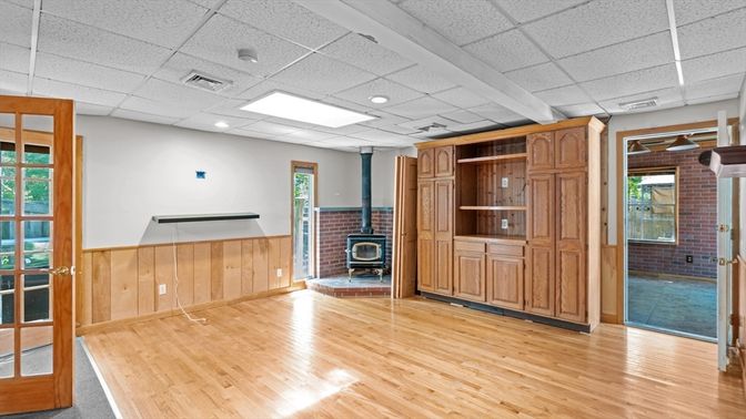Empty room, Fireplace, Interior, Recessed Lighting, Stone Walls, Wood Texture Flooring