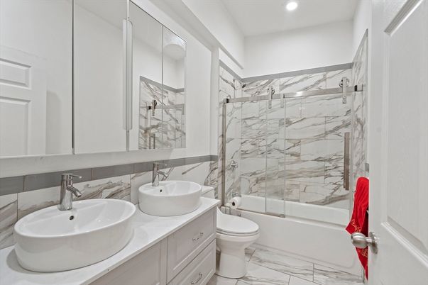 Bathroom, Dual Sink Vanities, Glass Shower, Interior, Marble, Marble Walls, Recessed Lighting