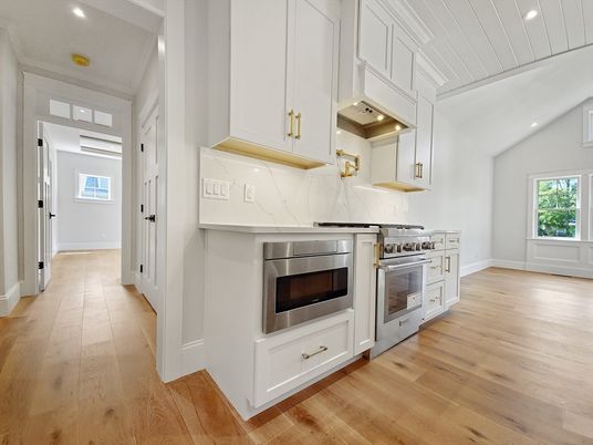 Interior, Kitchen, Marble Walls, Recessed Lighting, Stainless Steel Appliances, Wood Texture Flooring