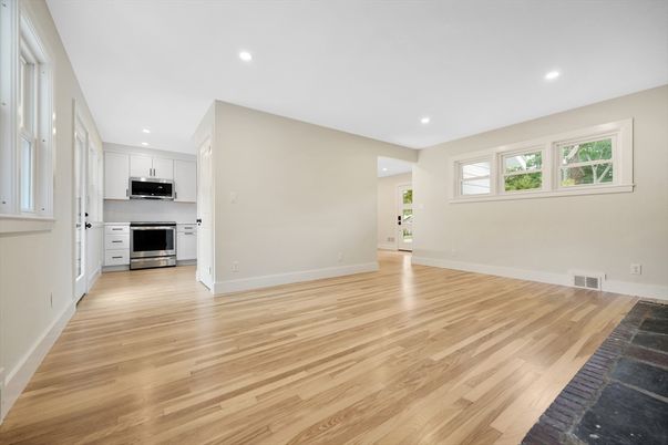 Empty room, Interior, Kitchen, Recessed Lighting, Stainless Steel Appliances, Wood Texture Flooring