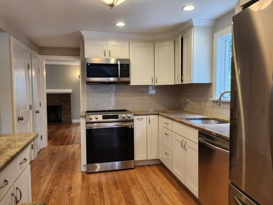 Fireplace, Interior, Kitchen, Recessed Lighting, Stainless Steel Appliances, Wood Texture Flooring