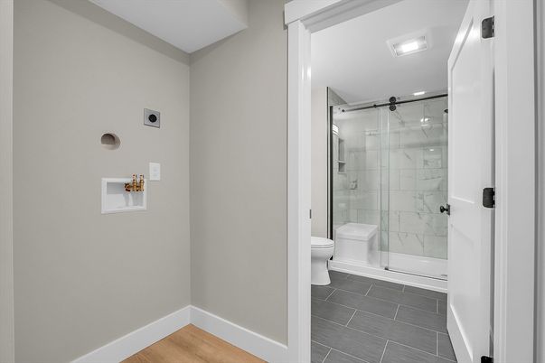 Bathroom, Glass Shower, Interior, Marble Walls, Recessed Lighting, Wood Texture Flooring