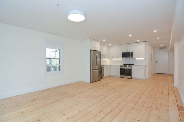 Empty room, Interior, Kitchen, Recessed Lighting, Stainless Steel Appliances, Wood Texture Flooring
