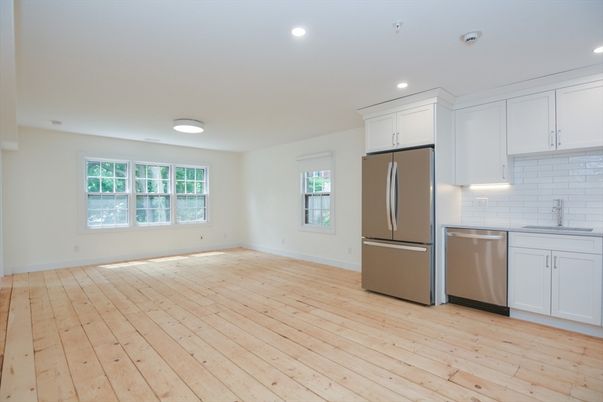 Empty room, Interior, Kitchen, Recessed Lighting, Stainless Steel Appliances, Wood Texture Flooring