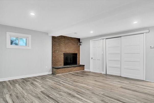 Empty room, Fireplace, Interior, Recessed Lighting, Stone Walls, Wood Texture Flooring