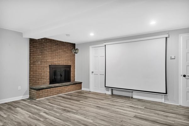 Empty room, Fireplace, Interior, Projection Screen, Recessed Lighting, Stone Walls, Wood Texture Flooring
