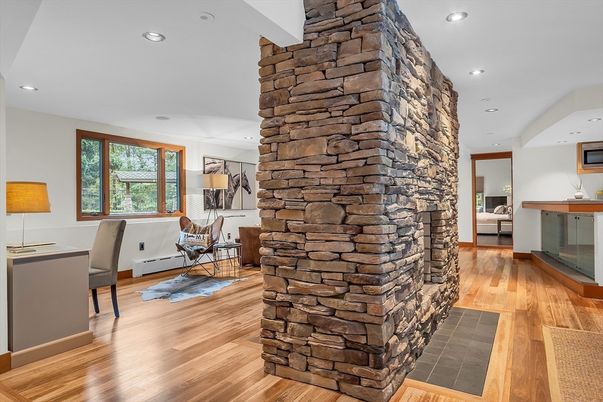 Fireplace, Interior, Living room, Recessed Lighting, Stone Walls, Wood Texture Flooring