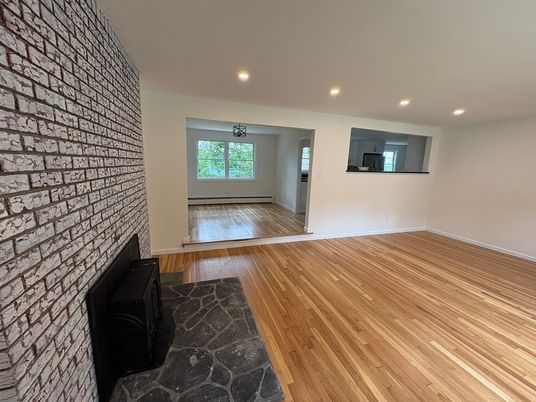 Empty room, Fireplace, Interior, Recessed Lighting, Stone Walls, Wood Texture Flooring