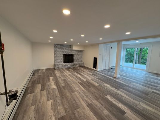 Empty room, Fireplace, Interior, Recessed Lighting, Stone Walls, Wood Texture Flooring