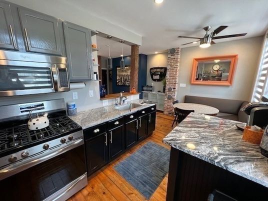 Dining room, Interior, Kitchen, Recessed Lighting, Stainless Steel Appliances, Stone Walls, Wood Texture Flooring